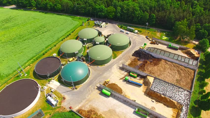 Biogas Plant And Farm In Green Fields. Renewable Energy From Biomass ...