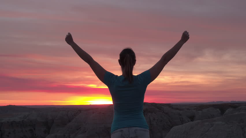 SLOW MOTION CLOSE UP: Young Woman Raising Her Hands On Top Of The ...