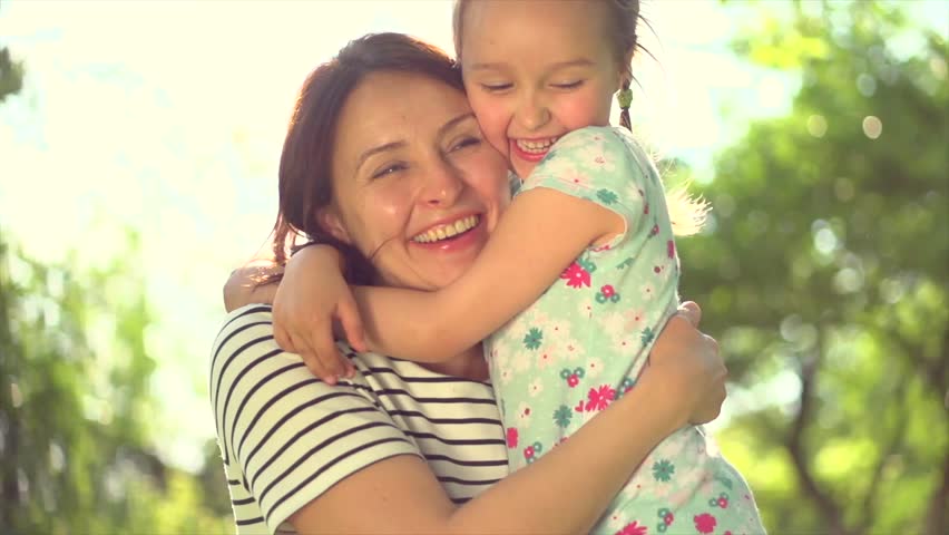 Little Girl Kisses And Hugs Her Mother In The Park Stock Footage Video