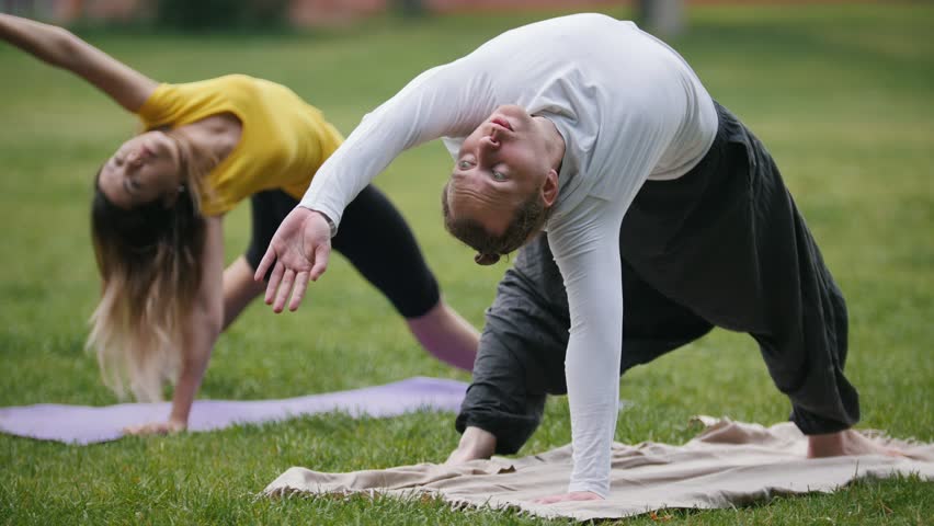 Healthy Retirees Doing A Windmill Arms Exercise In An Energetic Pace ...