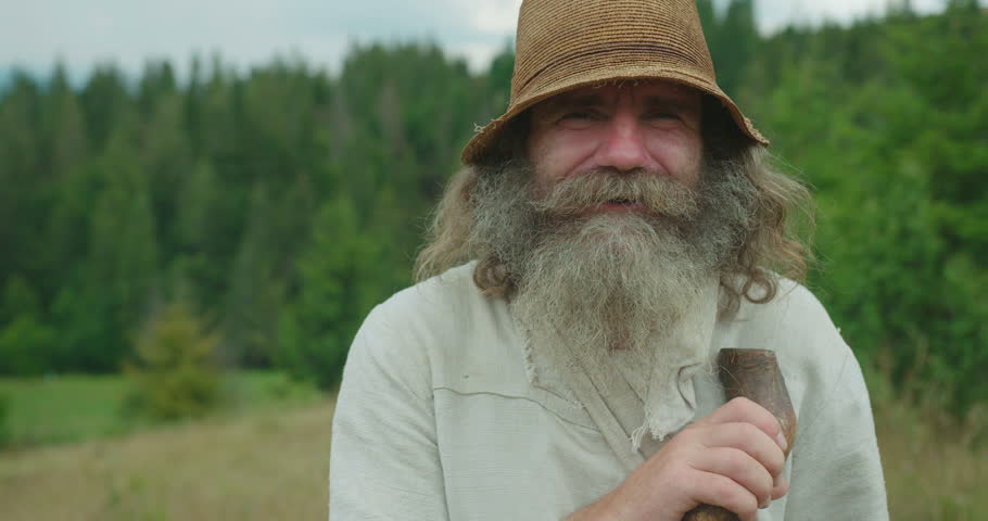 Close Up Portrait Of The Smiling Old Man With Long Hair And Beard