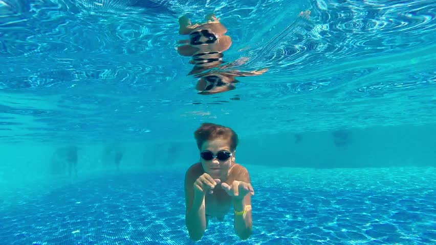 Brunette Swimming Underwater In The Pool In Slow Motion