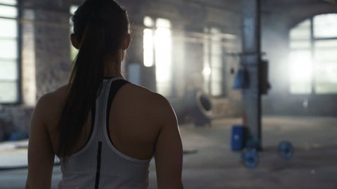Tiny Teen Hardcore Action - Follow-up shot of athletic beautiful woman entering gym in slow motion.  she's confident and pulls her ponytail, building is industrial and  hardcore. 8k uhd.