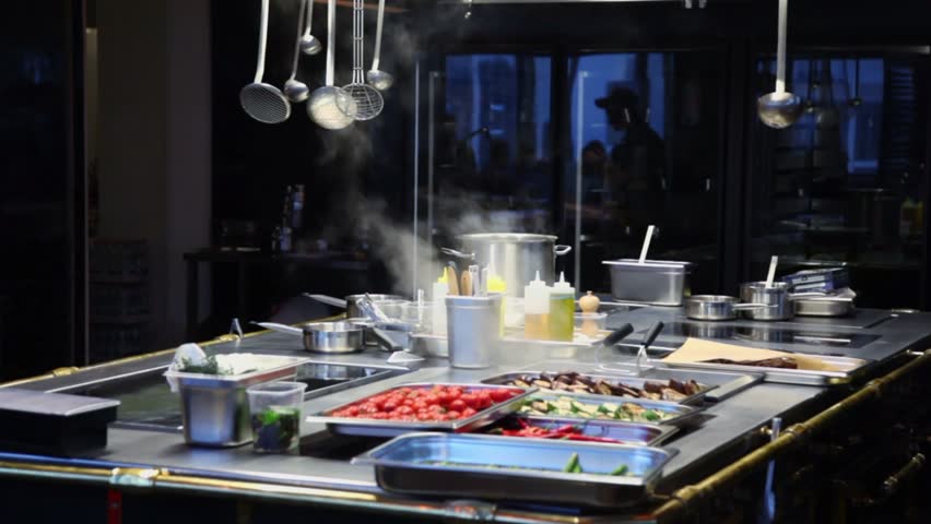 Restaurant Kitchen Utensils steam fumes above vegetables and kitchen utensils near glass with Restaurant Kitchen Utensils steam fumes above vegetables and kitchen utensils near glass with