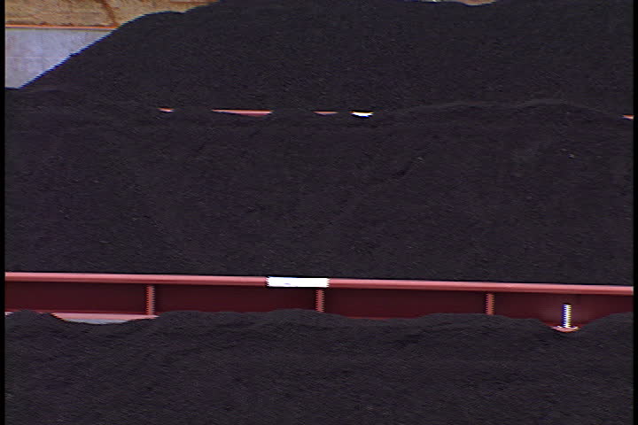Pan over loads of coal on coal barges in Metropolis, Illinois. - SD stock footage clip