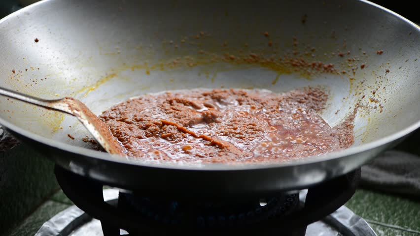 Cooking Curry Paste In A Asia Style Cast Iron Wok Stock Footage Video ...