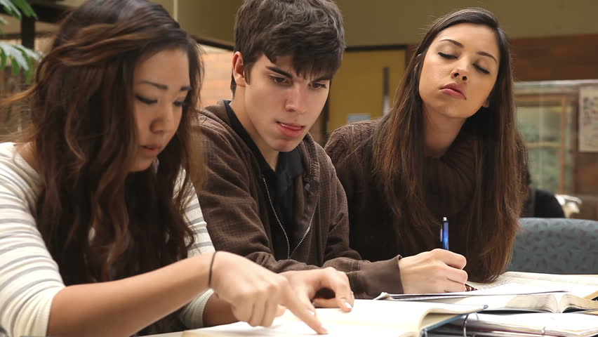 A Group Of College Students Work Together To Finish An Assignment Stock ...