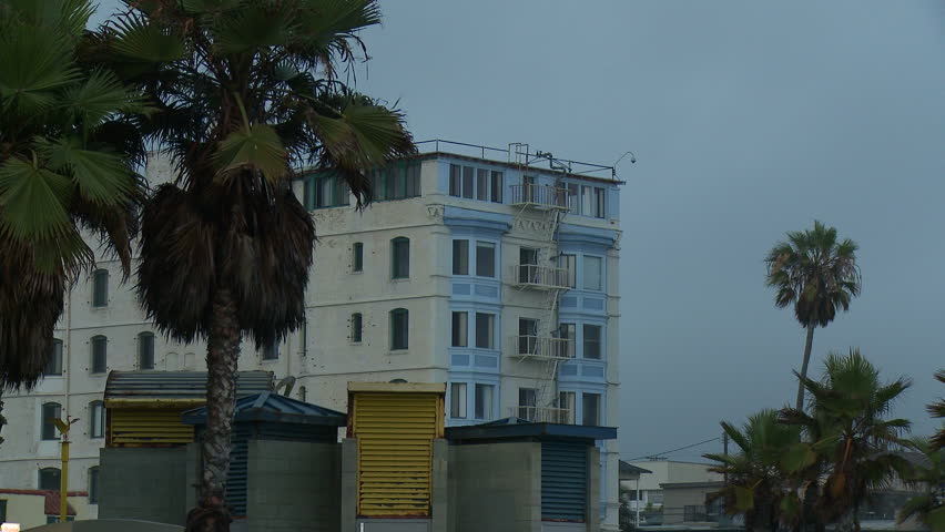 Hd00 09a Long Medium Shot Of A Vintage Apartment Building With Bay A Long Medium Shot Of Vintage Apartment Building With Bay Windows And Fire Escape That Sits On The Venice Beach Boardwalk In Los Angeles California