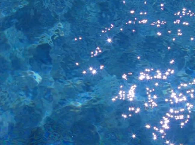 Dark Blue Pool Water sparkles on saturated blue sea background / close-up sunlight Dark Blue Pool Water sparkles on saturated blue sea background / close-up sunlight
