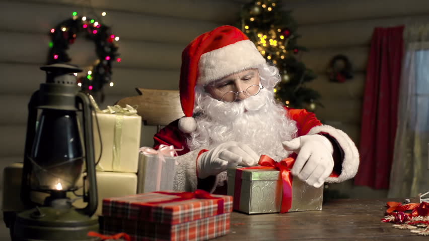 Stock Video Of Santa Claus Wrapping A Giftbox In
