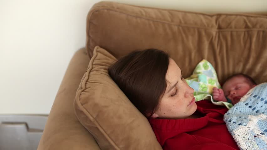 Hd00 15an Extremely Tired Mother Taking A Nap With Her Newborn