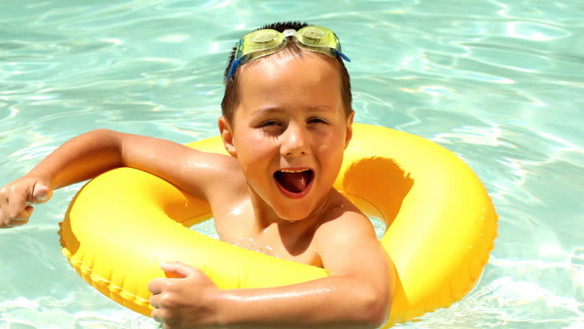 Young Boy Playing In A Swimming Pool On A Float Tube Stock Footage ...