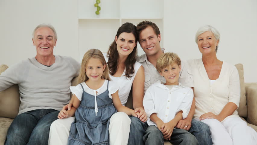 3-generation Family Sitting In Couch With Electronic Tablet Stock ...